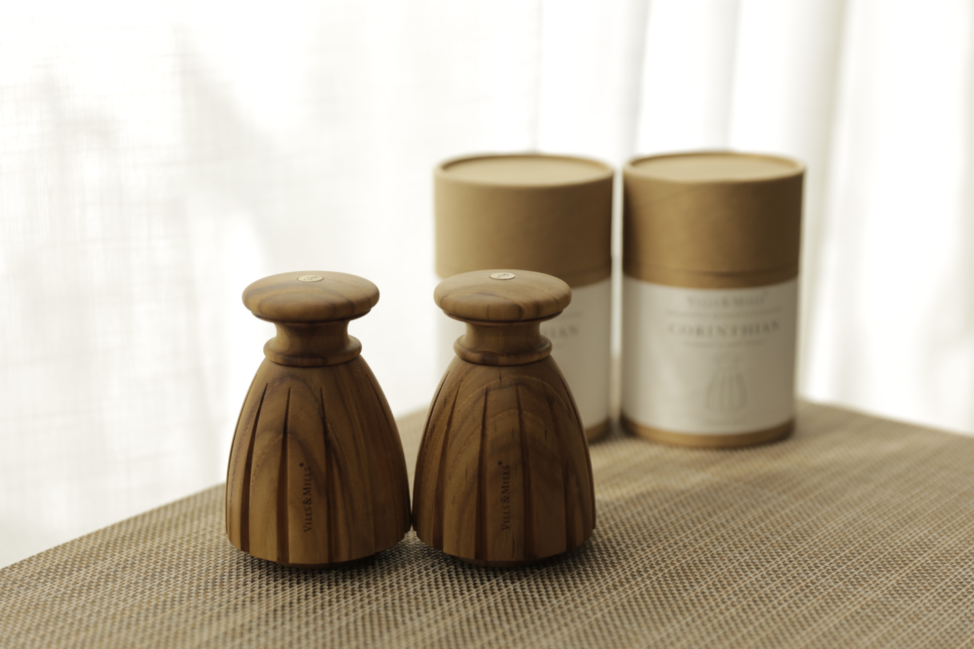 Corinthian salt and pepper mills — scalloped bell-shaped fluted bases beside their CORINTHIAN packaging tubes