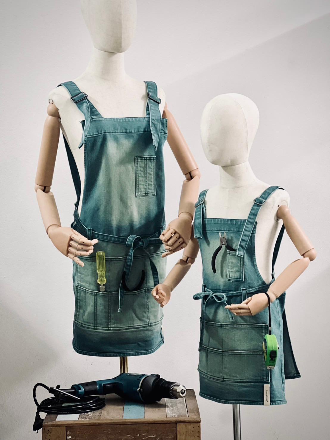 Carpenter denim tool apron in dark green with buckle straps, adult and child set